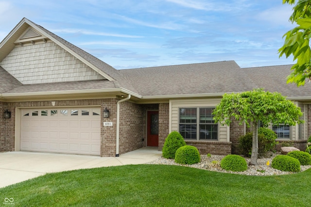 view of front facade with a shingled roof, an attached garage, and brick siding