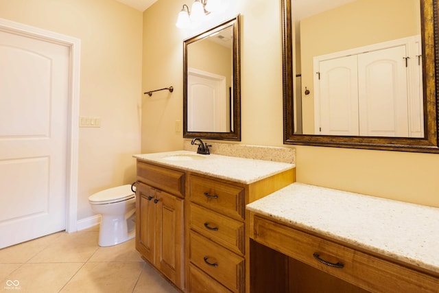 bathroom with vanity, tile patterned flooring, and toilet