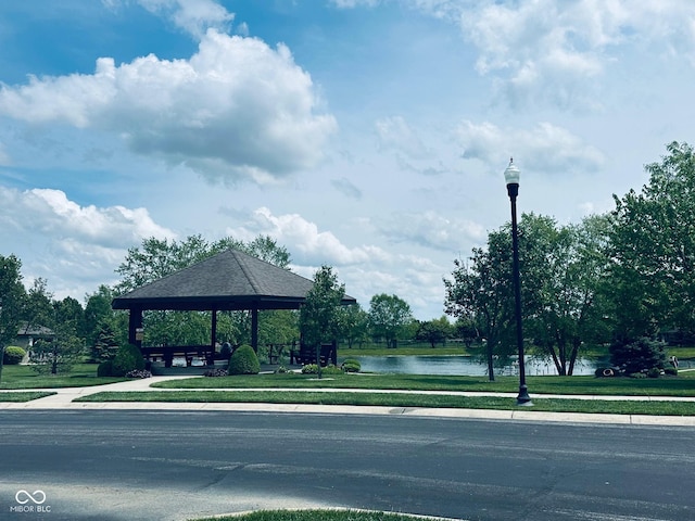 view of property's community featuring a gazebo, a water view, and a yard