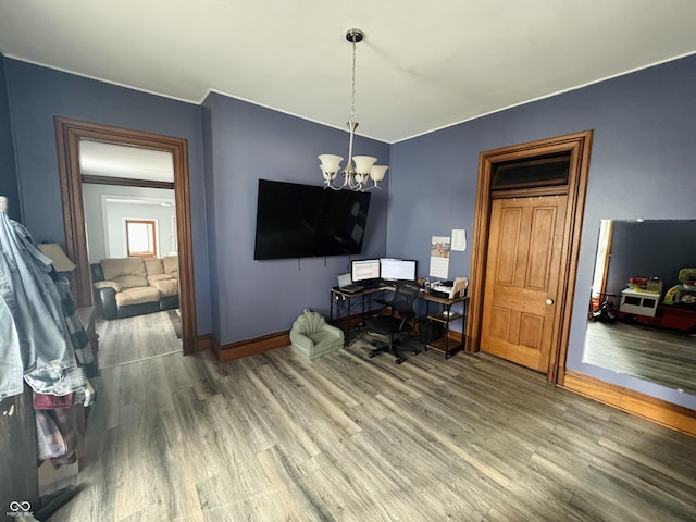 interior space featuring an inviting chandelier, wood finished floors, and baseboards