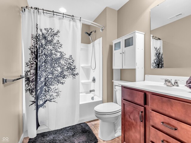 full bathroom with tile patterned flooring, shower / bath combo, toilet, vanity, and visible vents