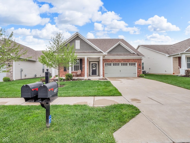 craftsman inspired home with a front yard, concrete driveway, a porch, and brick siding