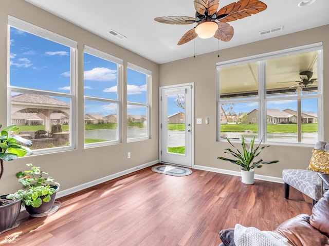 interior space with a ceiling fan, visible vents, and baseboards