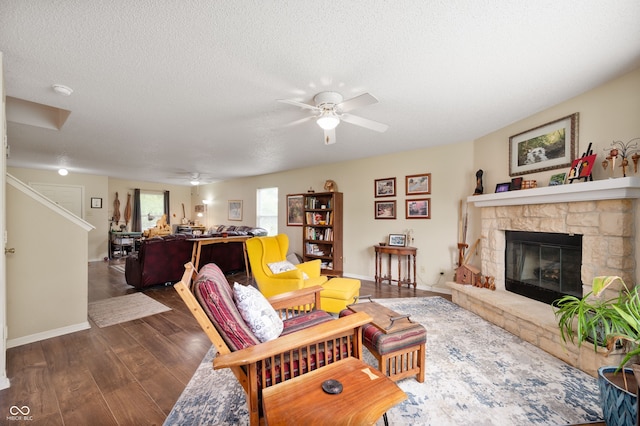 8211 Firefly Way, Indianapolis, IN 46259 - living room featuring a ceiling fan, wood finished floors, a fireplace, baseboards, and a textured ceiling