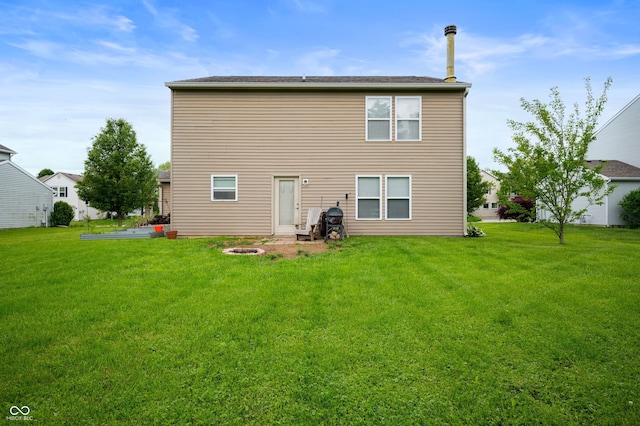 8211 Firefly Way, Indianapolis, IN 46259 - rear view of house with a lawn and a fire pit