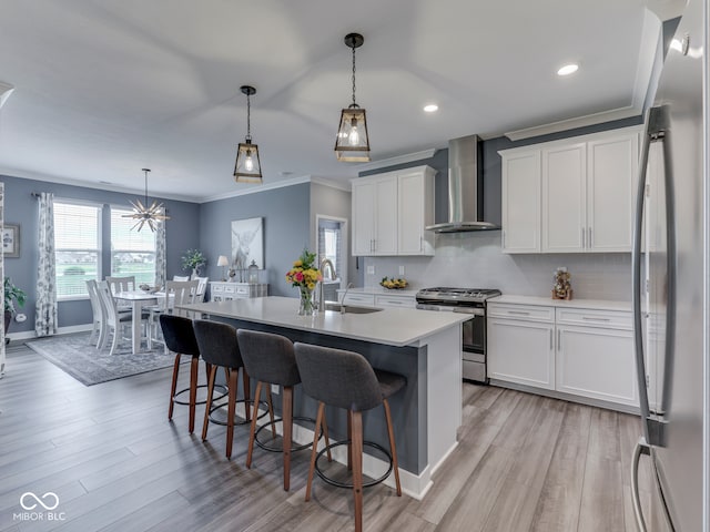 3697 Chalmers Dr, Bargersville, IN 46106 - kitchen with wall chimney exhaust hood, stainless steel appliances, a sink, light countertops, and a kitchen breakfast bar