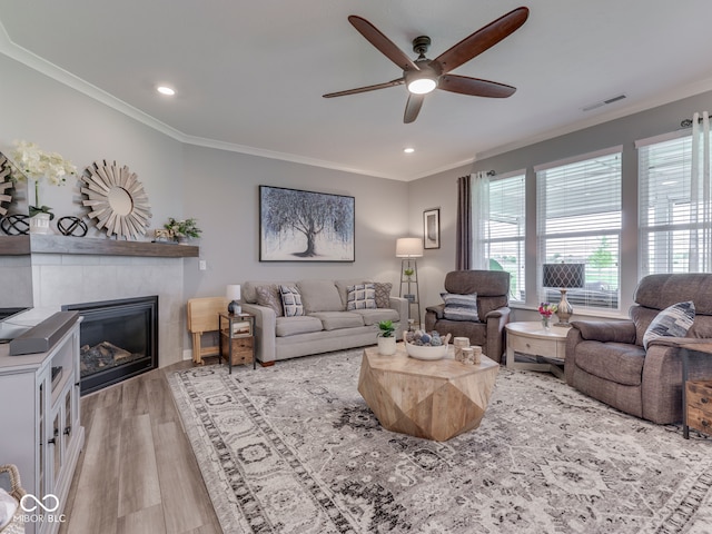 3697 Chalmers Dr, Bargersville, IN 46106 - living room with ceiling fan, wood finished floors, crown molding, a tile fireplace, and recessed lighting