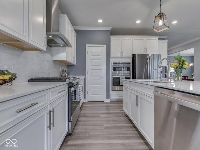 3697 Chalmers Dr, Bargersville, IN 46106 - kitchen with stainless steel appliances, wall chimney range hood, crown molding, recessed lighting, and light countertops