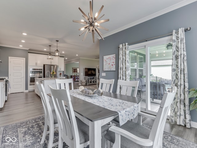 3697 Chalmers Dr, Bargersville, IN 46106 - dining space featuring ornamental molding, a chandelier, recessed lighting, light wood-style floors, and baseboards