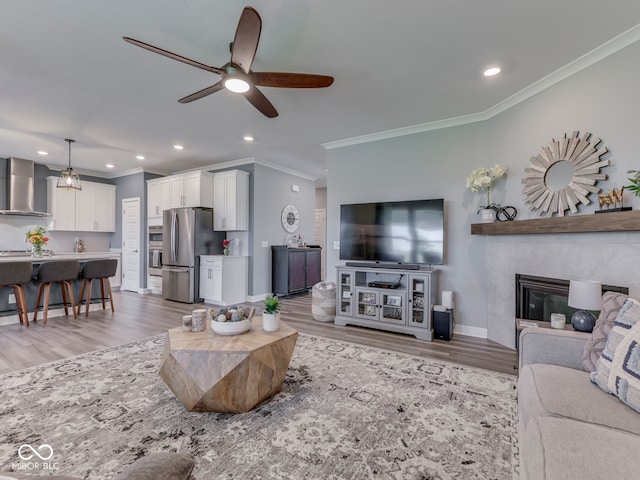 3697 Chalmers Dr, Bargersville, IN 46106 - living area with crown molding, light wood finished floors, a ceiling fan, recessed lighting, and baseboards
