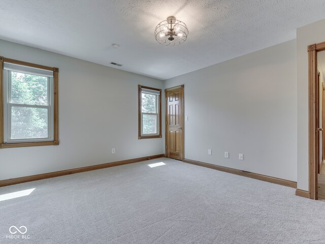 3601 Lakeshore Ct, Greenwood, IN 46143 - spare room with plenty of natural light, carpet, and a textured ceiling