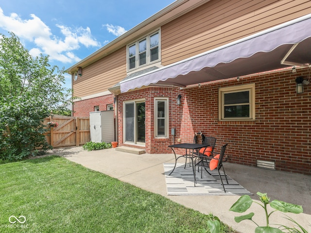 3601 Lakeshore Ct, Greenwood, IN 46143 - rear view of house featuring a gate, brick siding, and a patio area