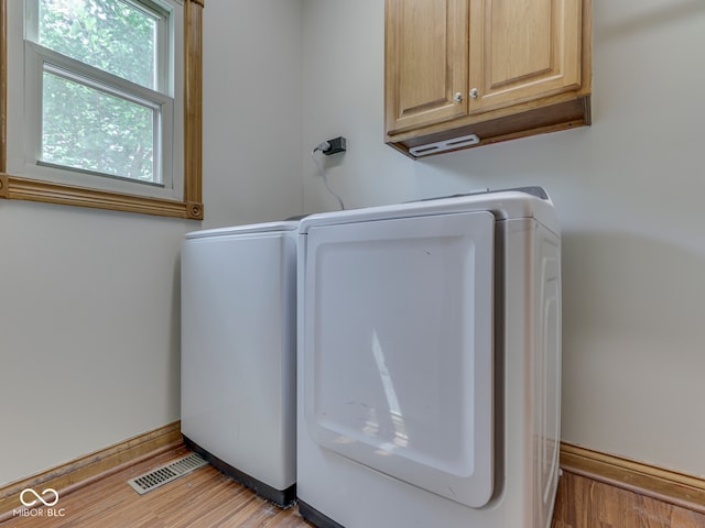 3601 Lakeshore Ct, Greenwood, IN 46143 - washroom featuring cabinet space, light wood-style floors, and washing machine and clothes dryer
