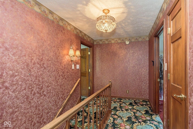 7901 Oaklandon Rd, Indianapolis, IN 46236 - hall featuring carpet flooring, a textured ceiling, a chandelier, baseboards, and an upstairs landing