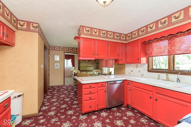 7901 Oaklandon Rd, Indianapolis, IN 46236 - kitchen featuring stainless steel dishwasher, a peninsula, light countertops, a textured ceiling, and a sink