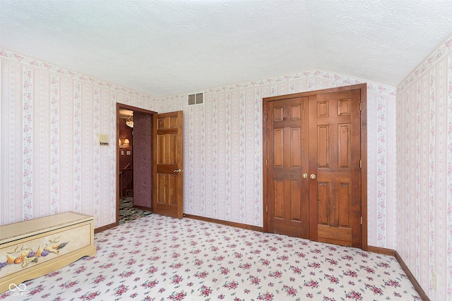 7901 Oaklandon Rd, Indianapolis, IN 46236 - carpeted bedroom with a textured ceiling, visible vents, and baseboards