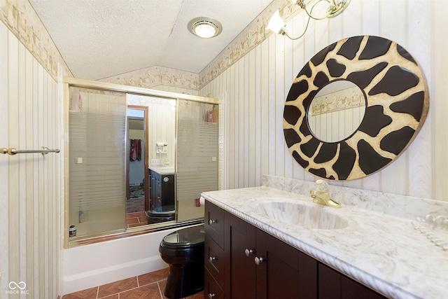 7901 Oaklandon Rd, Indianapolis, IN 46236 - bathroom with vanity, toilet, a textured ceiling, combined bath / shower with glass door, and vaulted ceiling
