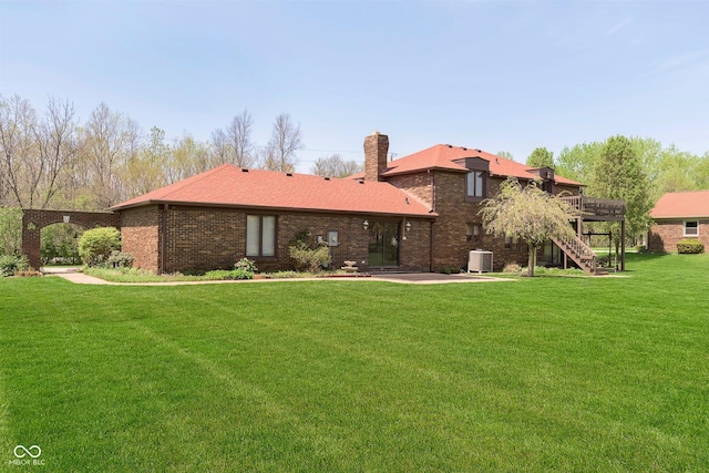 7901 Oaklandon Rd, Indianapolis, IN 46236 - back of house with a wooden deck, a chimney, central air condition unit, a yard, and stairway