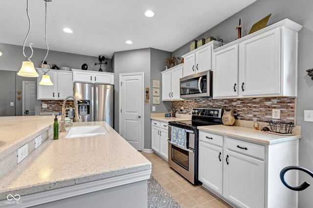 4809 Ozark Ln, Indianapolis, IN 46239 - kitchen with appliances with stainless steel finishes, white cabinetry, and decorative backsplash