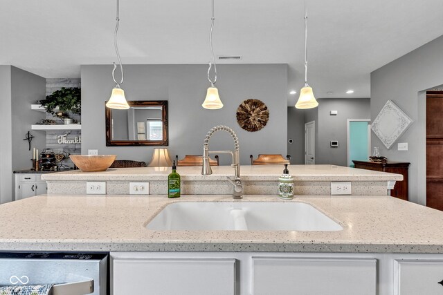 4809 Ozark Ln, Indianapolis, IN 46239 - kitchen featuring white cabinetry, visible vents, light stone countertops, and a sink