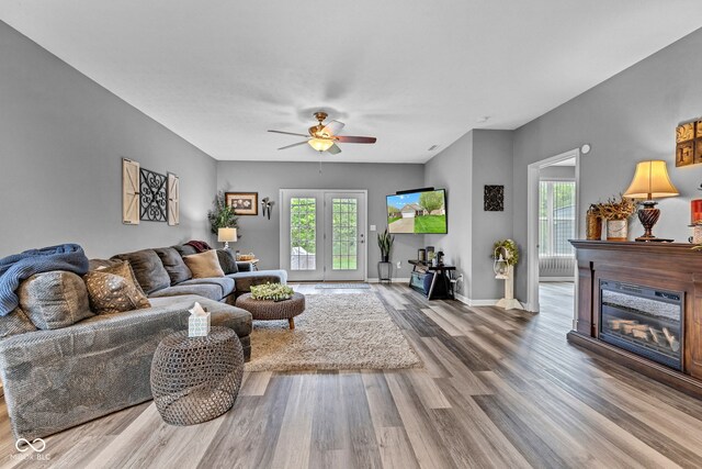 4809 Ozark Ln, Indianapolis, IN 46239 - living area featuring baseboards, wood finished floors, ceiling fan, and a glass covered fireplace