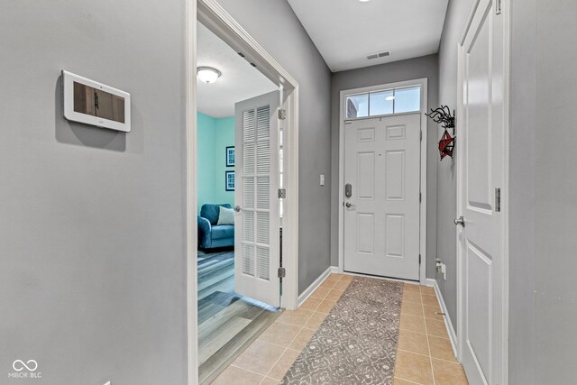 4809 Ozark Ln, Indianapolis, IN 46239 - entrance foyer with baseboards, visible vents, and light tile patterned floors
