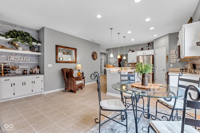 4809 Ozark Ln, Indianapolis, IN 46239 - dining area with light tile patterned flooring, recessed lighting, a bar, and baseboards