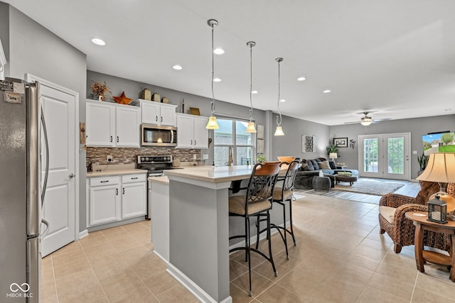 4809 Ozark Ln, Indianapolis, IN 46239 - kitchen with light countertops, open floor plan, stainless steel appliances, and a healthy amount of sunlight