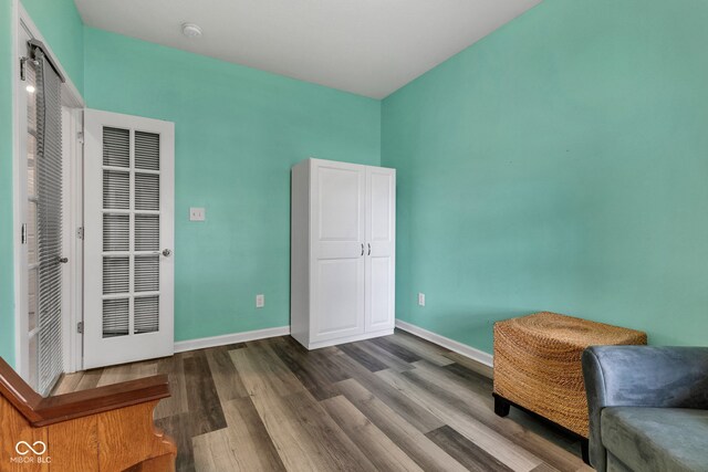 4809 Ozark Ln, Indianapolis, IN 46239 - sitting room with dark wood-style floors and baseboards