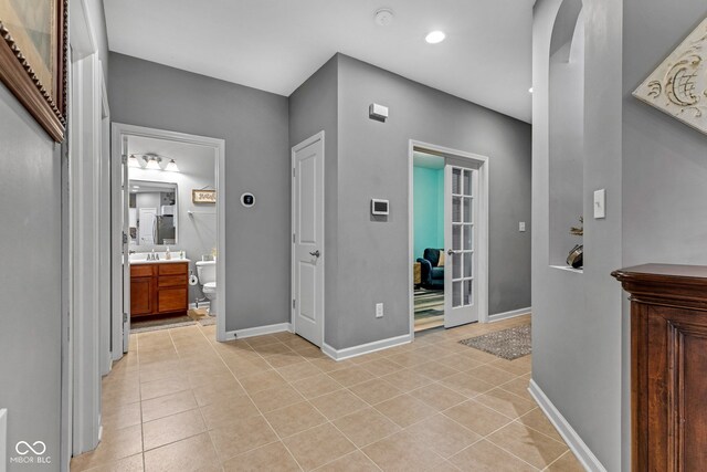 4809 Ozark Ln, Indianapolis, IN 46239 - hall featuring recessed lighting, light tile patterned flooring, and baseboards