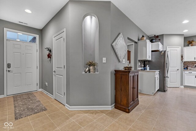 4809 Ozark Ln, Indianapolis, IN 46239 - foyer featuring baseboards, visible vents, light tile patterned floors, and recessed lighting