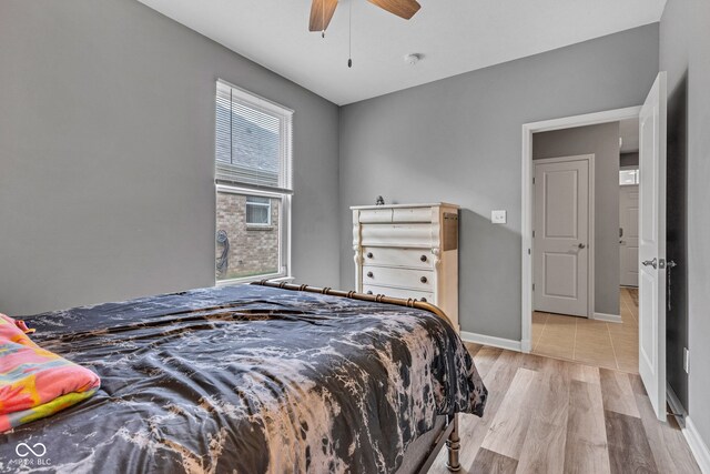 4809 Ozark Ln, Indianapolis, IN 46239 - bedroom with light wood-style floors, a ceiling fan, and baseboards