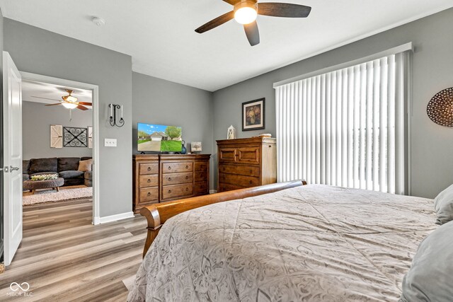 4809 Ozark Ln, Indianapolis, IN 46239 - bedroom with wood finished floors, ceiling fan, and baseboards