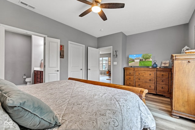 4809 Ozark Ln, Indianapolis, IN 46239 - bedroom with ceiling fan, visible vents, ensuite bathroom, and light wood finished floors