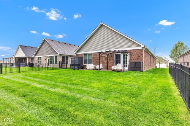 4809 Ozark Ln, Indianapolis, IN 46239 - back of property featuring brick siding, a fenced backyard, and a yard