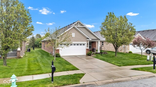 4809 Ozark Ln, Indianapolis, IN 46239 - view of front of home featuring brick siding, a front yard, concrete driveway, and an attached garage