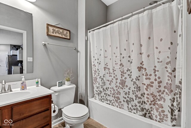 4809 Ozark Ln, Indianapolis, IN 46239 - full bath with washer / dryer, toilet, shower / bath combination with curtain, vanity, and tile patterned flooring
