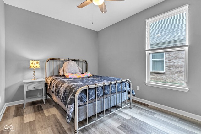 4809 Ozark Ln, Indianapolis, IN 46239 - bedroom with wood finished floors, ceiling fan, and baseboards