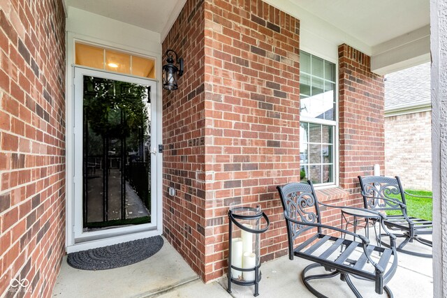 4809 Ozark Ln, Indianapolis, IN 46239 - view of exterior entry featuring covered porch and brick siding