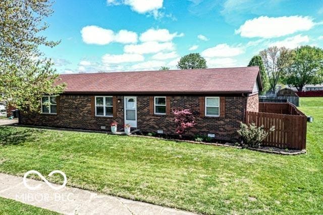 single story home featuring brick siding, fence, and a front lawn