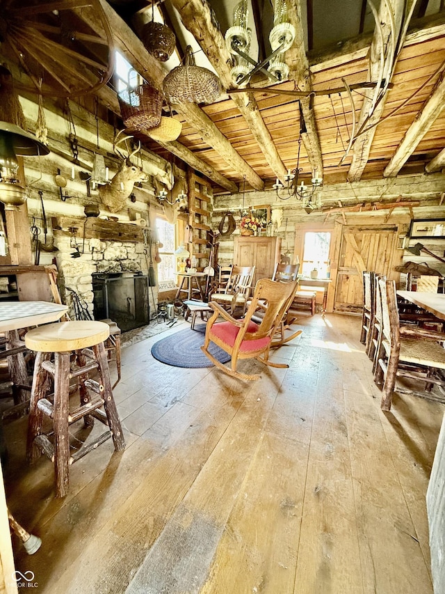 misc room with a fireplace, hardwood / wood-style floors, beam ceiling, and wood ceiling