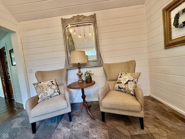 living area featuring wooden walls