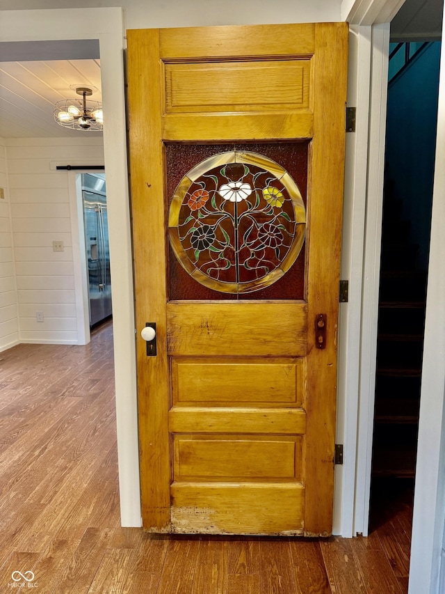 details featuring wood finished floors and a notable chandelier