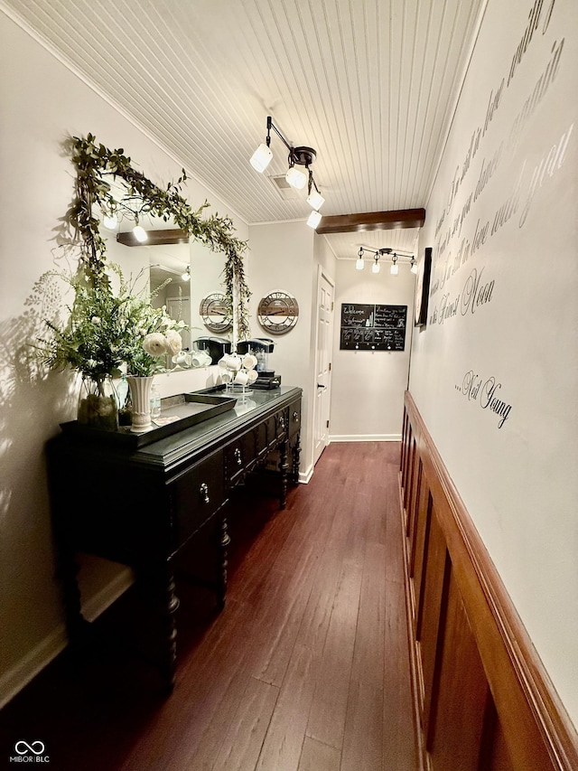 interior space featuring crown molding, wooden ceiling, baseboards, wood-type flooring, and rail lighting