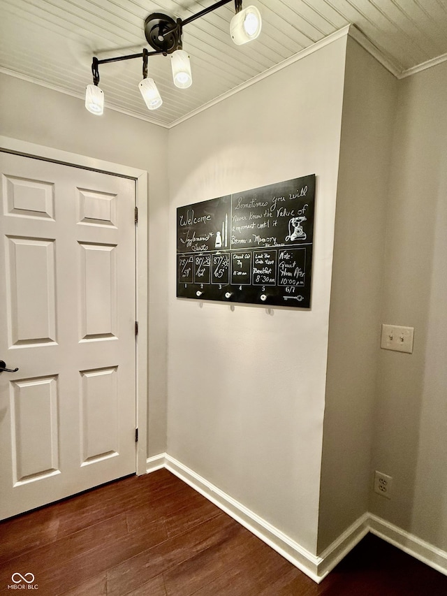 interior space with baseboards, ornamental molding, and wood ceiling
