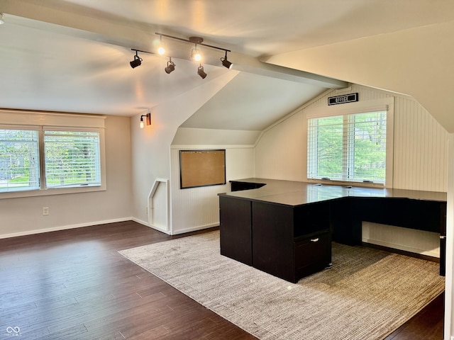 unfurnished office with dark wood-style flooring, plenty of natural light, and vaulted ceiling