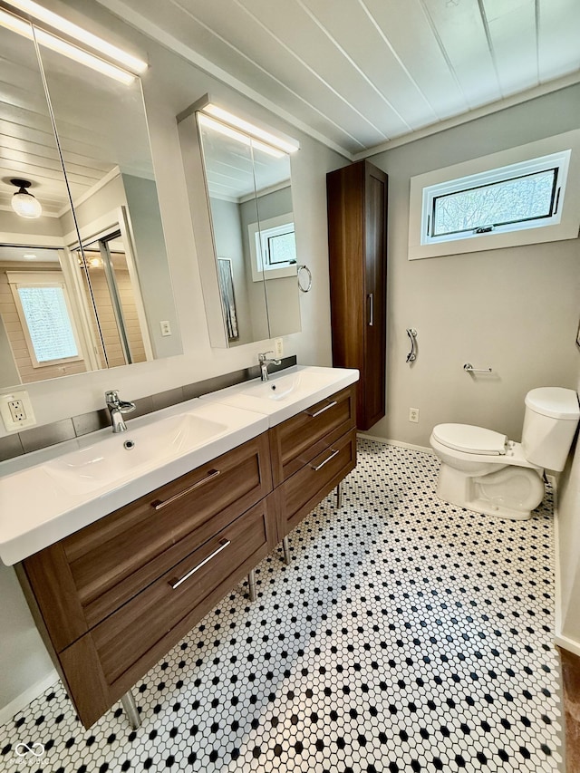 full bath featuring plenty of natural light, toilet, and a sink