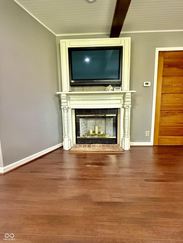 unfurnished living room featuring a glass covered fireplace, wood finished floors, crown molding, and baseboards