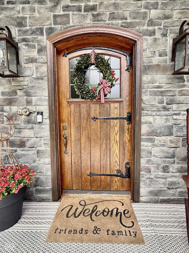 view of exterior entry featuring stone siding