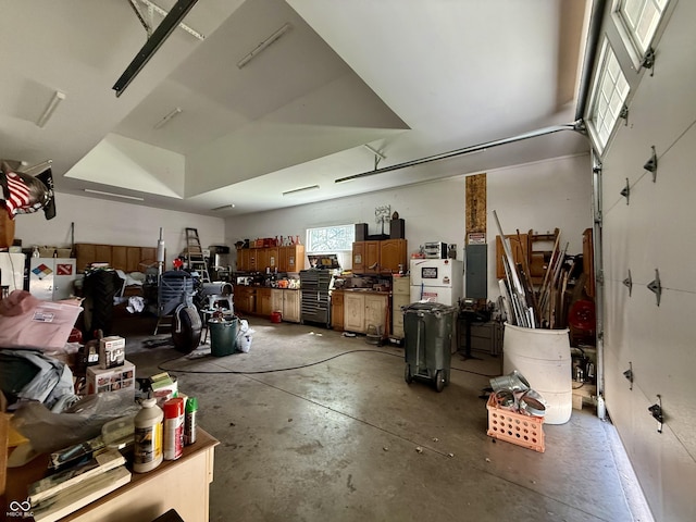 garage with a workshop area and electric panel